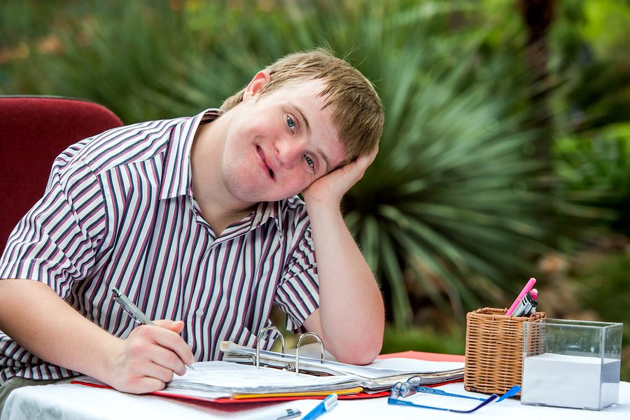 Teen with a learning disability completing his homework