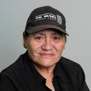 Her hat reads; "Te Kura Kaupapa. Māori o te waiū o ngāti porou."