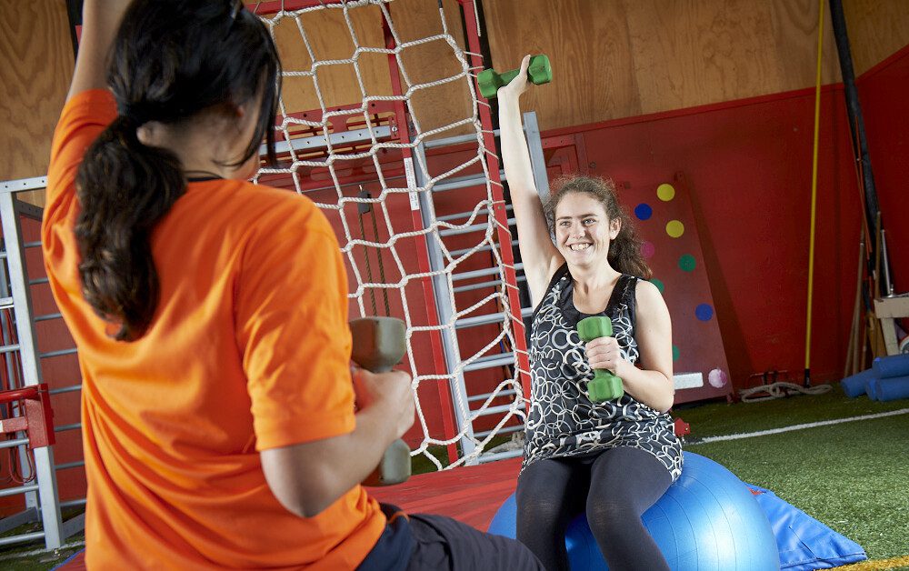 Two young people exercising at the gym