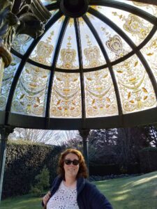Suzie Linton smiling. She is standing under the cupola at Larnach Castle Dunedin - August 2021