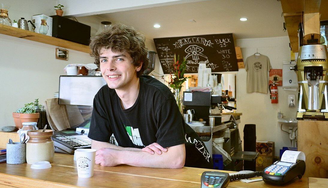 Young man at his new job in cafe