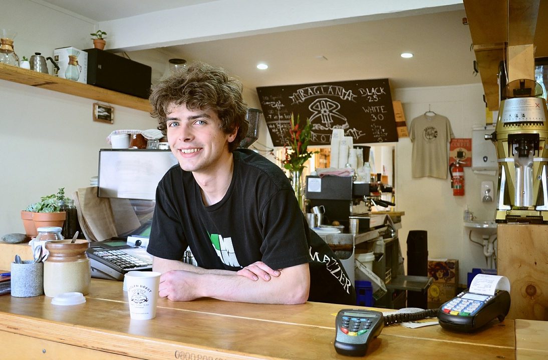 Young man at his new job in cafe