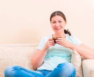 Girl Sitting On The Couch In The Living Room