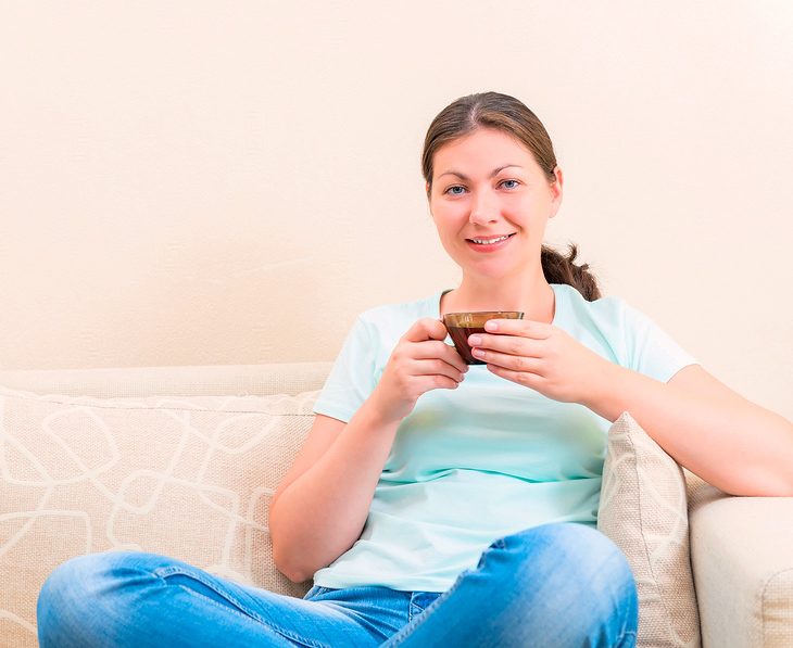 Girl Sitting On The Couch with a cup of tea
