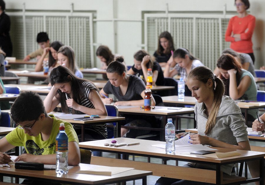 Students sitting in a hall for a school exam