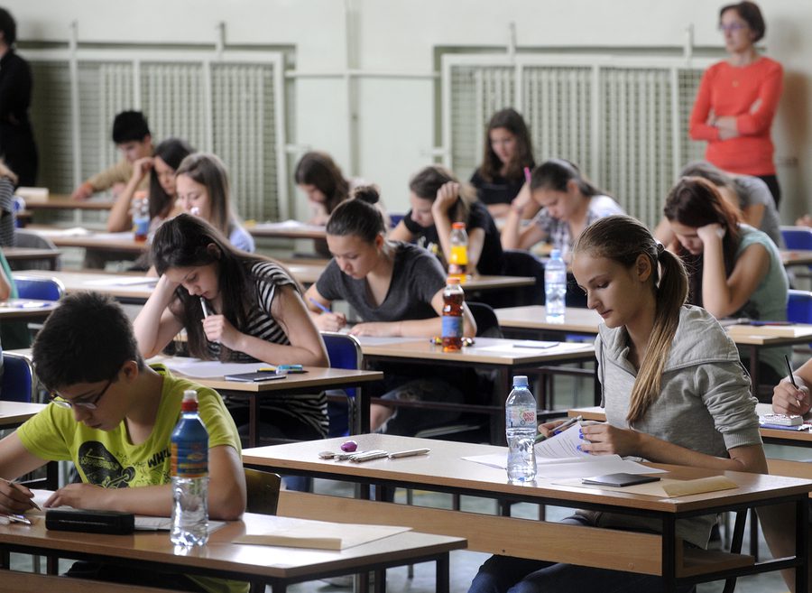 Students sitting in a hall for a school exam