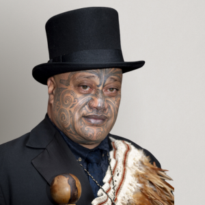 Dr Pouroto Ngaropo Wears a tall tophat and kākahu (Māori cloak).